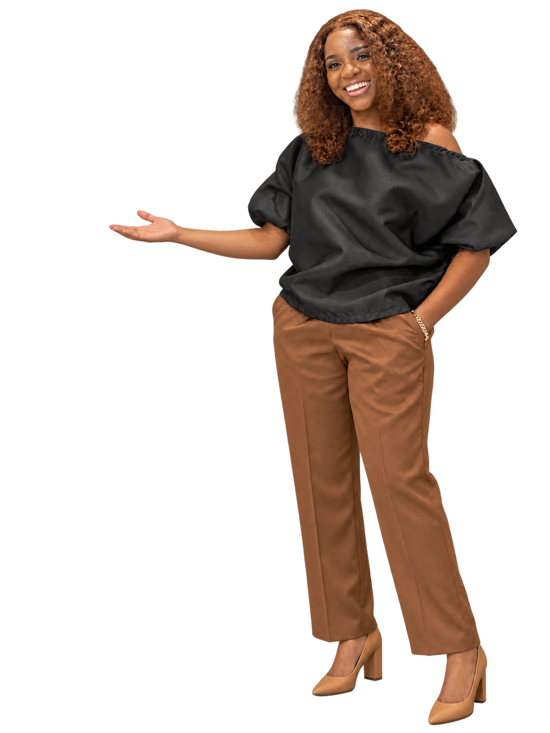 Abee smiling in a black top and brown trousers, with one hand extended to welcome you into the room.